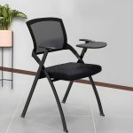 A fold-up training chair with a writing pad, designed for easy storage and comfortable seating, perfect for training rooms or seminars.