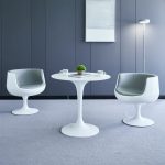 Modern round white dining table with a sleek design, perfect for contemporary dining rooms and stylish home interiors.