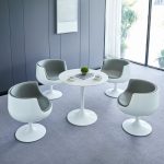 Modern round white dining table with a sleek design, perfect for contemporary dining rooms and stylish home interiors.