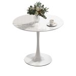 Modern round white dining table with a sleek design, perfect for contemporary dining rooms and stylish home interiors.