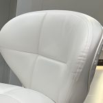 Simple black leather square bar stool with a modern design and sturdy base.