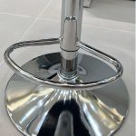 Simple black leather square bar stool with a modern design and sturdy base.