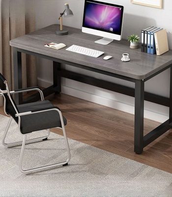 A simple and functional generic computer table with a spacious work surface, drawers, and sturdy legs, perfect for home or office use.