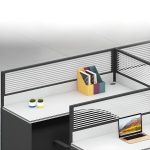 A modern office workstation setup featuring four desks, each equipped with a computer, ergonomic chair, and storage. The space is bright, minimalistic, and designed for productivity.