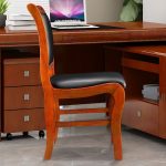 A wooden visitor’s office chair with a comfortable padded seat, sturdy wooden frame, and armrests, offering a stylish seating option for office guests.