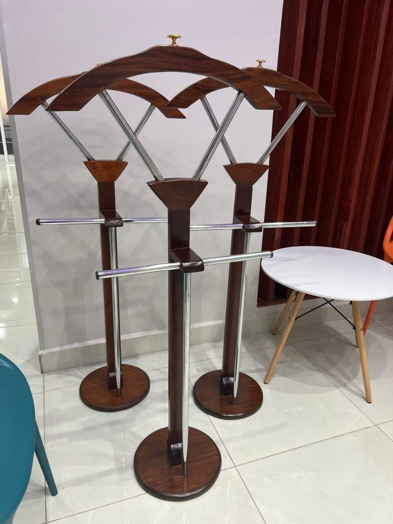 A classic mahogany jacket hanger featuring a polished wood finish and sturdy hooks, perfect for organizing jackets and coats in any room.
