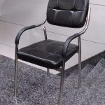 A modern Catalina guest chair in sleek black, featuring a minimalist design with comfortable armrests and sturdy legs.