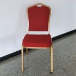 Stackable conference banquet chairs with a cushioned seat and backrest, featuring a sturdy metal frame for easy storage and versatile use.