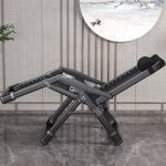 A fold-away recliner armchair with a comfortable headrest, featuring a modern design for easy storage and relaxation in any space.