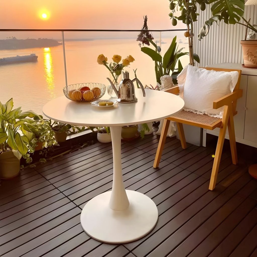 A sleek and modern round white dining table, featuring a minimalist design that fits perfectly into contemporary dining spaces.