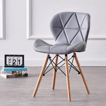 A stylish Eames dining chair with a molded plastic seat in a neutral color, sleek wooden legs, and a modern design, perfect for contemporary dining spaces.